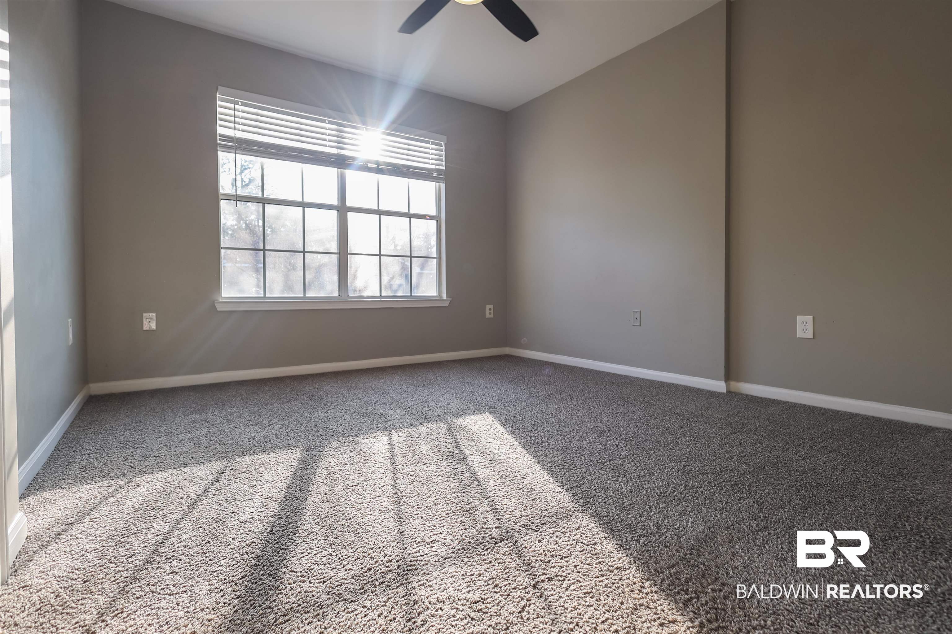 1517 Regency Road, Unit 125 Gulf Shores, AL 36542 - Photo 17 of 26 Spare room with carpet and ceiling fan