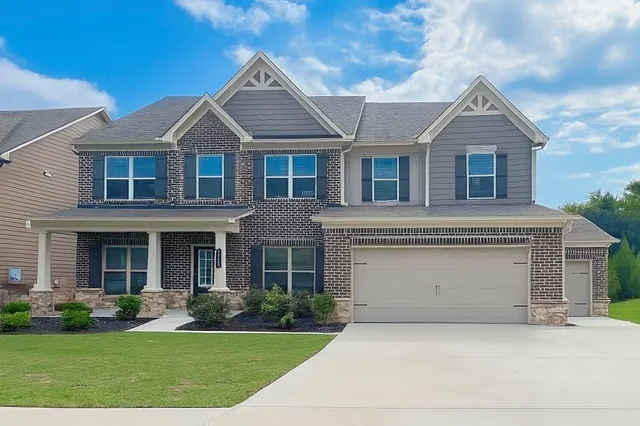 a front view of a house with a yard and garage