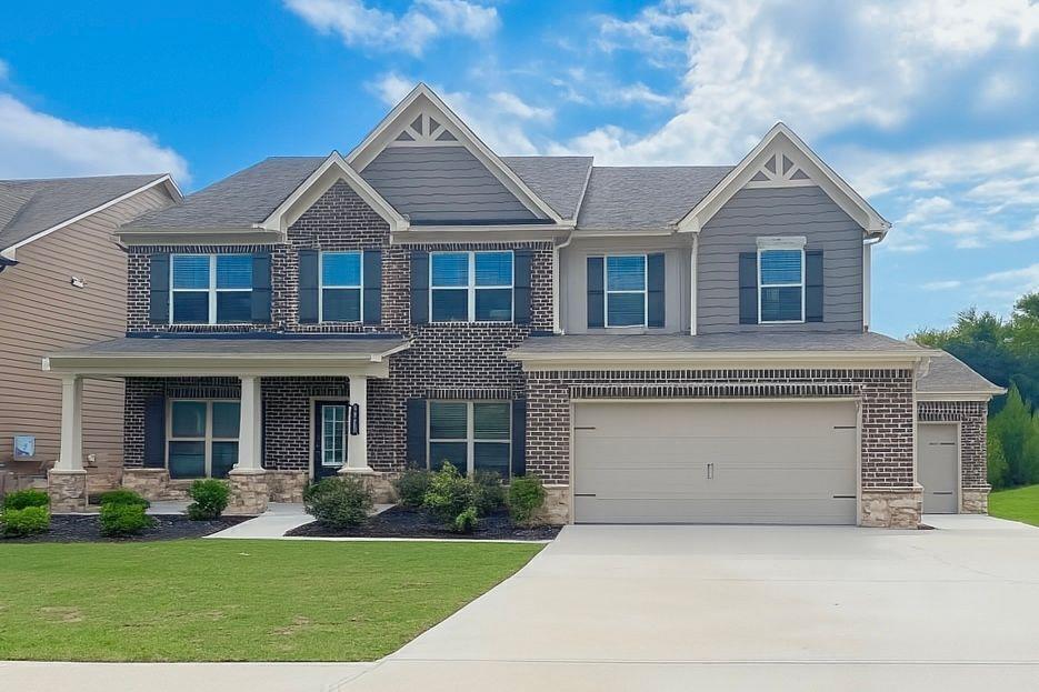 a front view of a house with a yard and garage