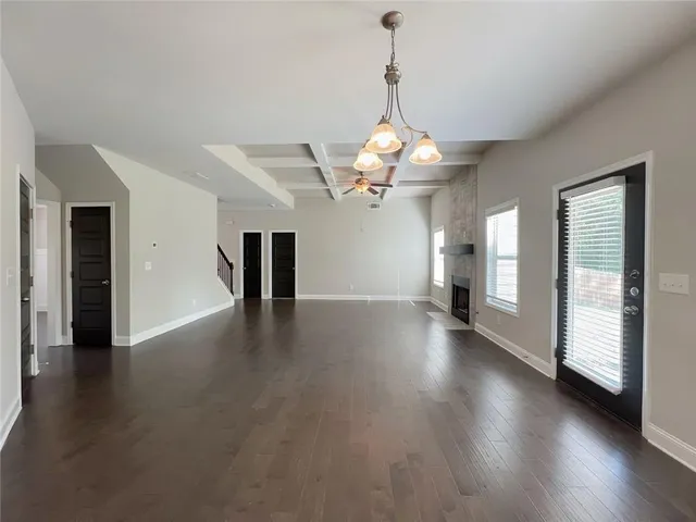 a large kitchen with stainless steel appliances granite countertop a stove a sink a refrigerator and white cabinets