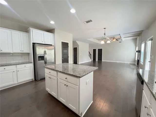 a kitchen with a sink cabinets and window