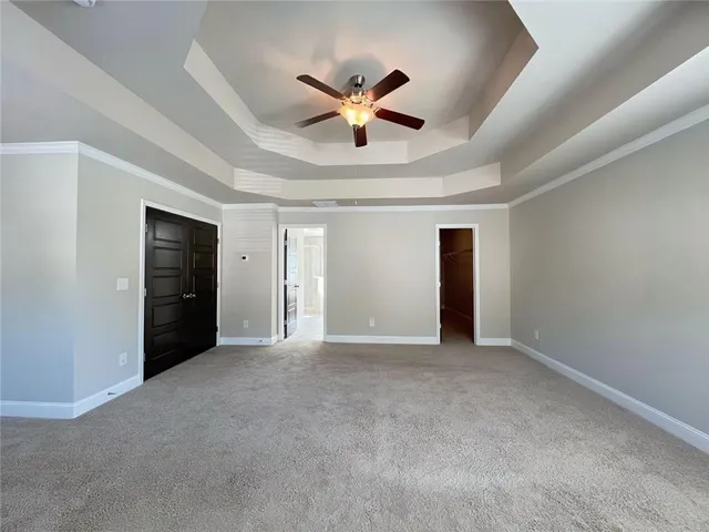 a spacious bathroom with a tub sink and mirror