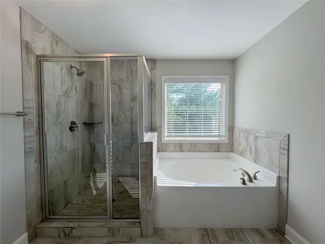 an empty room with a window and closet