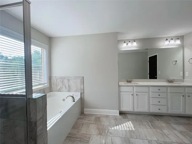 a bathroom with a double vanity sink and a mirror