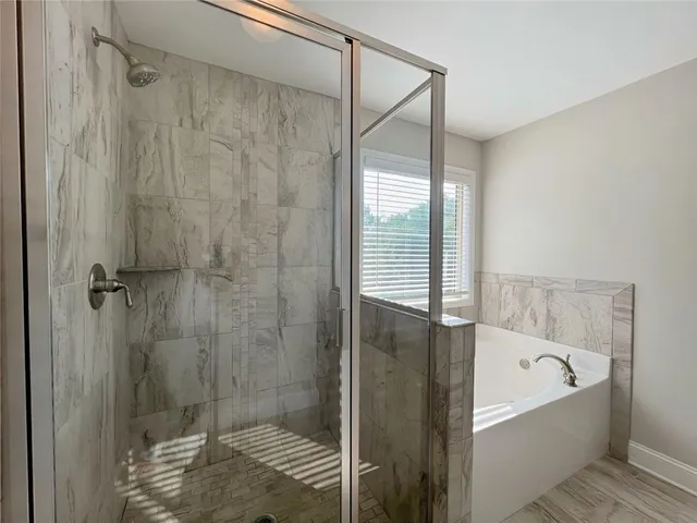 a bathroom with a bathtub and a shower