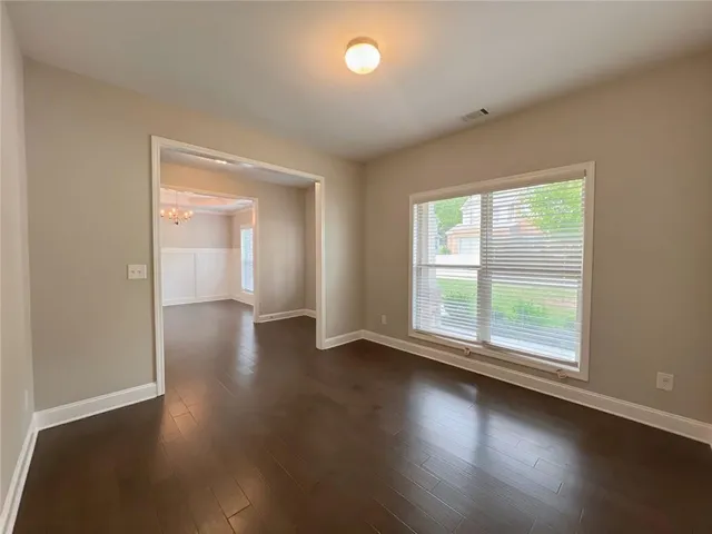 a view of a work space with wooden floor and a ceiling fan