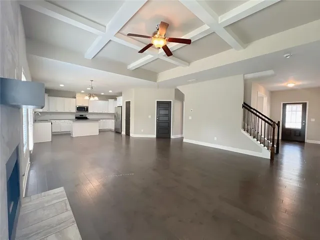 a view of a livingroom with wooden floor and a chandelier