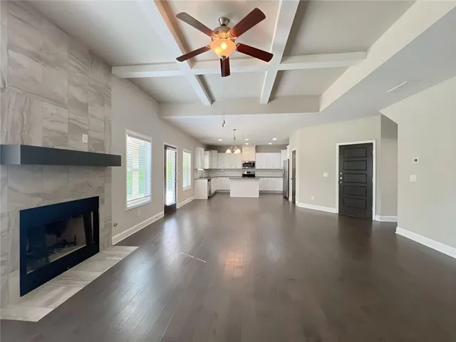 a large kitchen with white cabinets stainless steel appliances a sink and a window