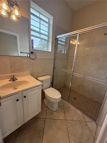 a bathroom with a toilet a sink and a shower