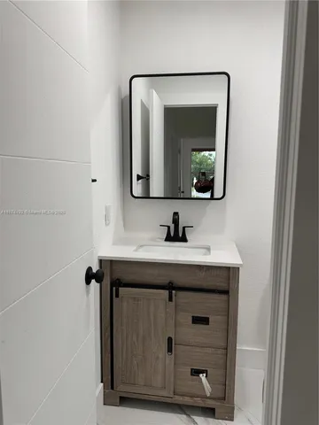 a bathroom with a sink and a mirror