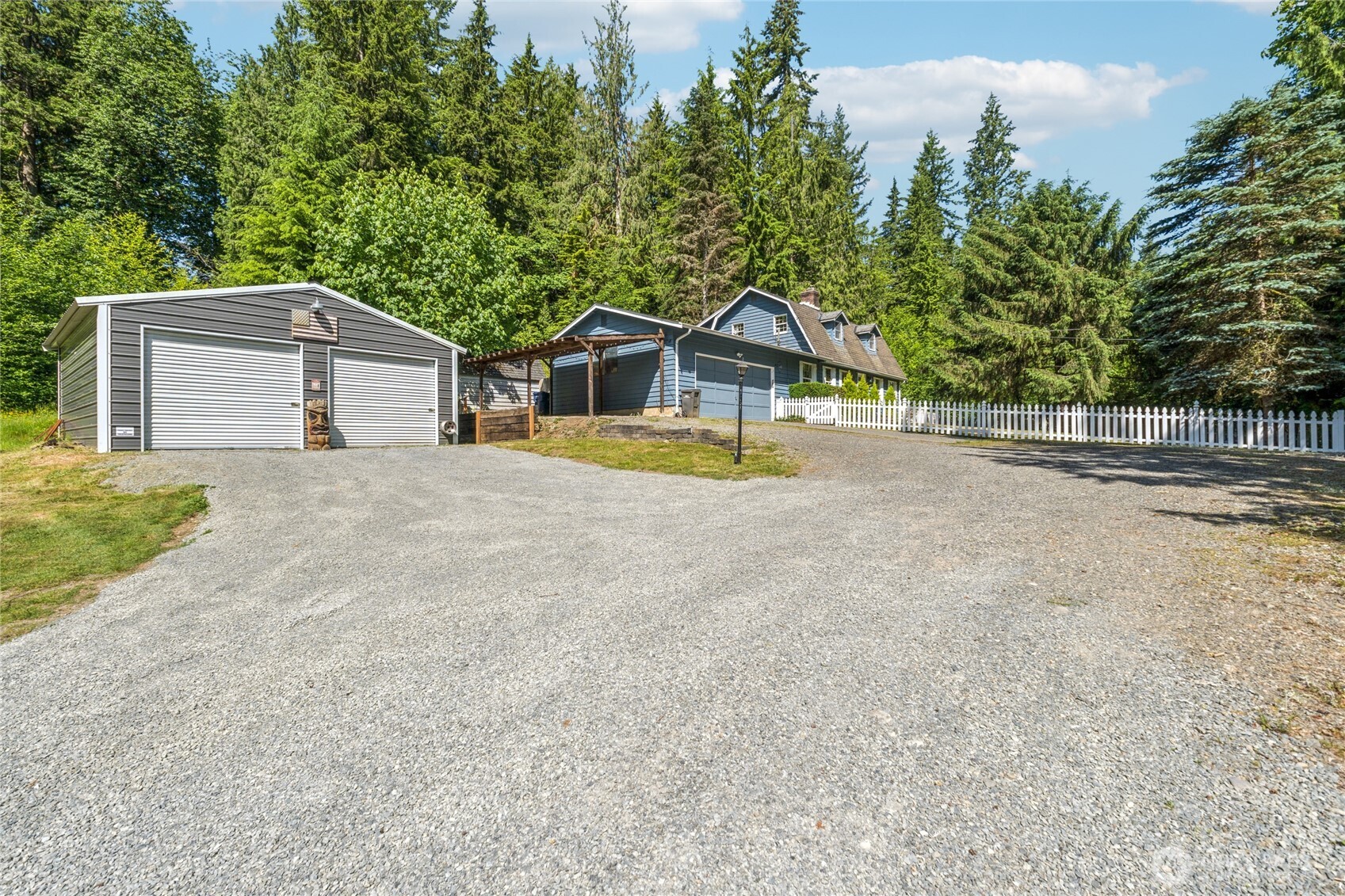 2216 Newberg Road Snohomish, WA 98290 - Photo 2 of 32 a front view of a house with a yard and garage