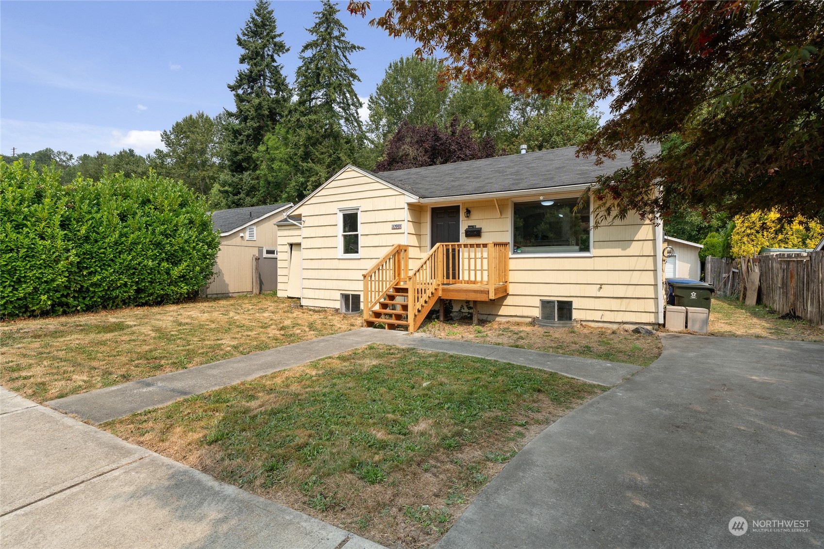 3106 Southeast 5th Street Renton, WA 98058 - Photo 2 of 21 a view of a white house with a yard plants and large tree