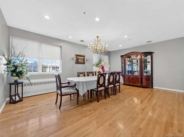 a view of a dining room with furniture and a chandelier