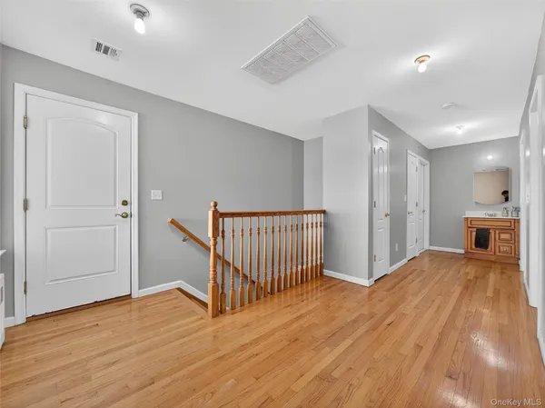 a bedroom with a bed and a large mirror