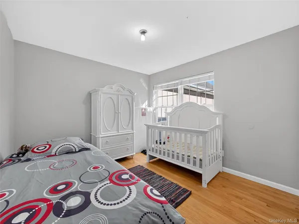 a bedroom with two beds and wooden floor