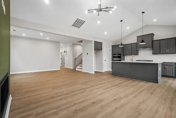 a view of kitchen with kitchen island a sink appliances and cabinets