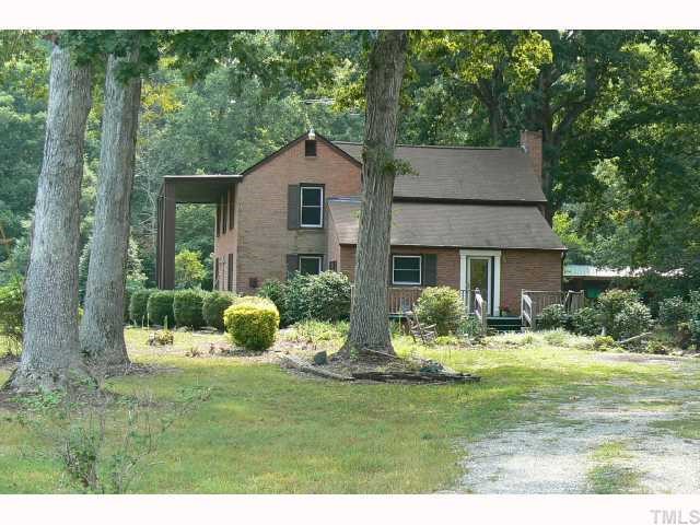 1822 Bushy Cook Road Efland, NC 27243 - Photo 3 of 9 The side view of the property at the end of the drive. Note the large deck which overlooks the garden area.