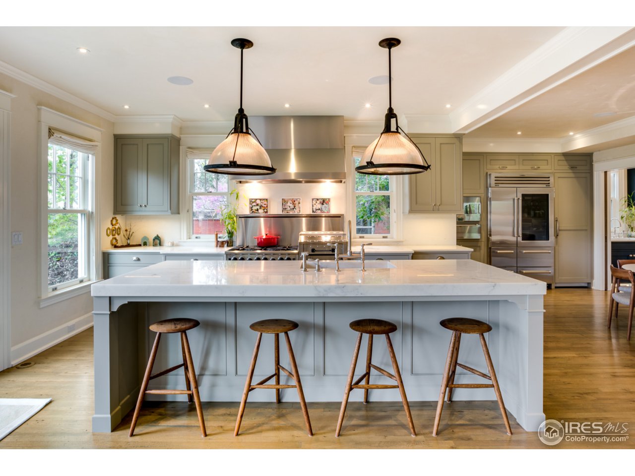 933 Mapleton Avenue Boulder, CO 80304 - Photo 3 of 14 a kitchen with stainless steel appliances kitchen island a dining table chairs and a wooden floor