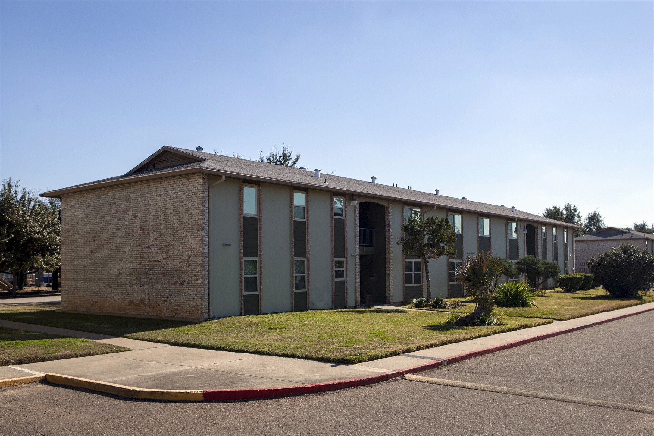 300 East Mann Road Laredo, TX 78041 - Photo 3 of 15 a view of a brick house with a small yard and a large parking space