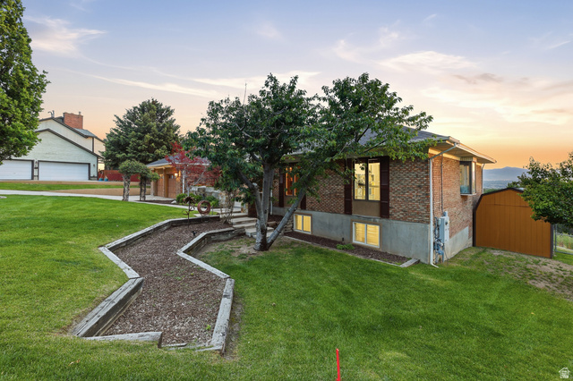 2342 Charros Road Sandy, UT 84092 - Photo 68 of 94 Brick exterior residence featuring a terraced front yard with mature trees
