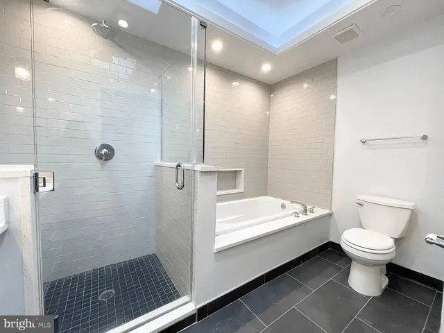 a view of an empty room with wooden floor and closet