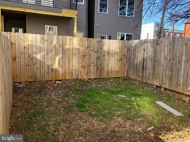 an empty room with wooden floor & closet