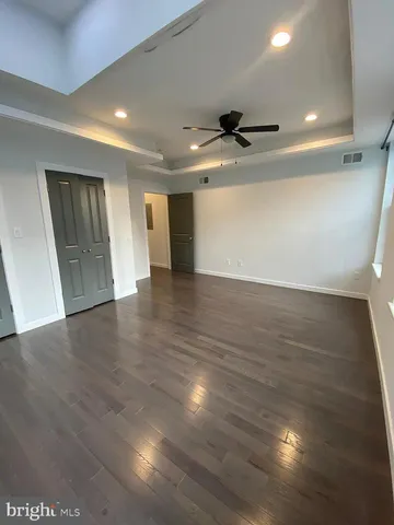 a view of kitchen with stainless steel appliances kitchen island granite countertop a refrigerator and a stove top oven