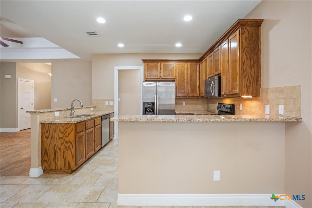 198 Sheridan Loop Belton, TX 76513 - Photo 13 of 31 a large kitchen with kitchen island a sink stainless steel appliances and cabinets