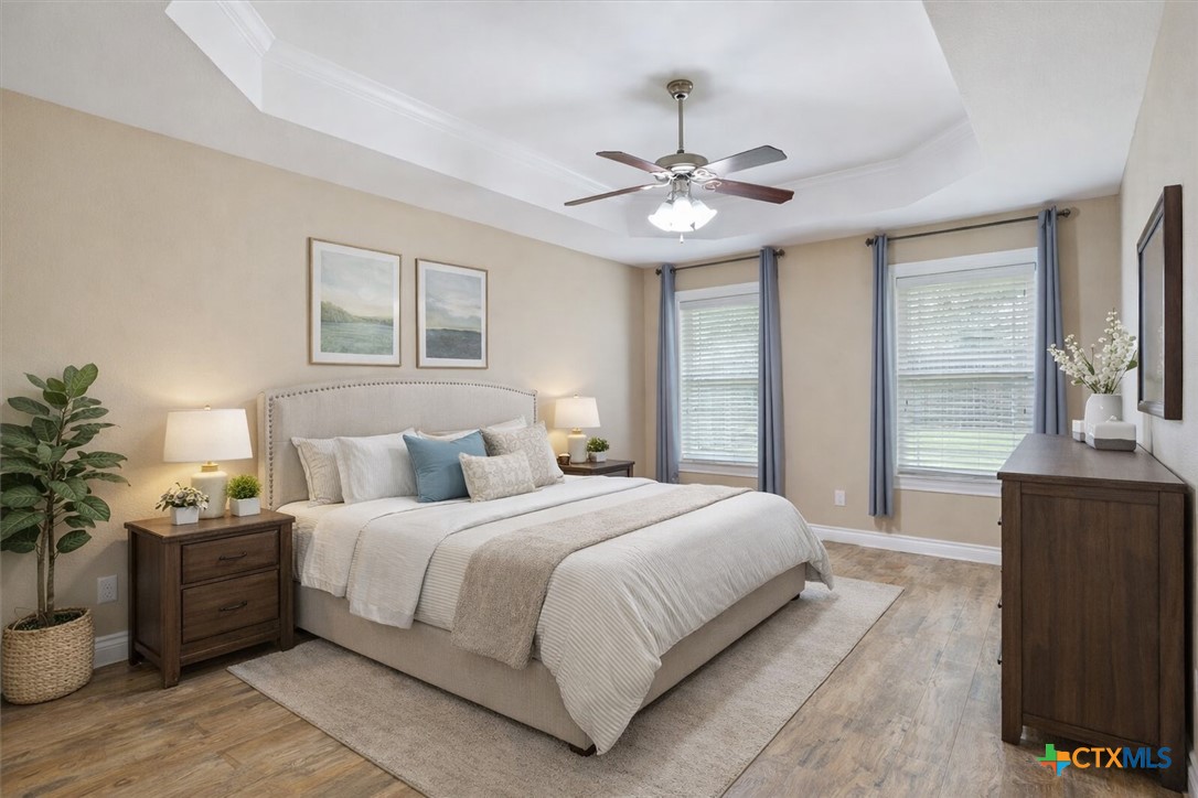 198 Sheridan Loop Belton, TX 76513 - Photo 17 of 31 a bedroom with a large bed and a chandelier