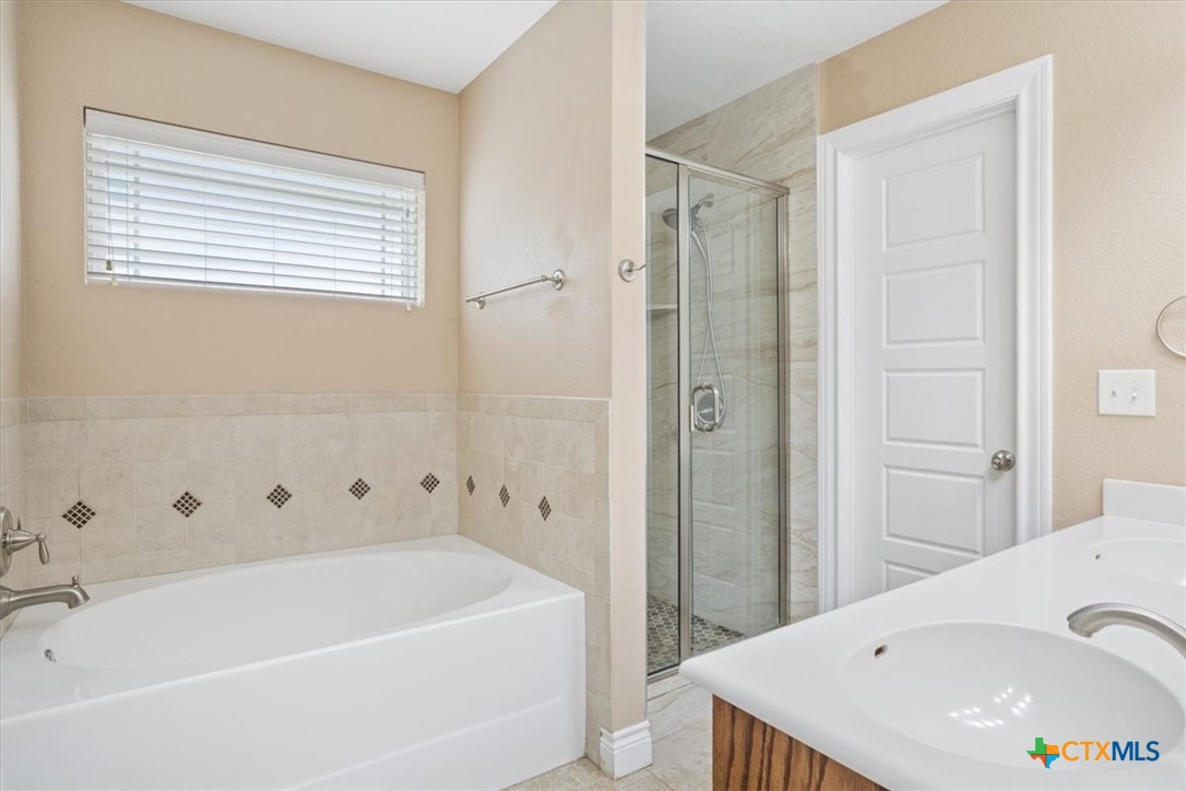 198 Sheridan Loop Belton, TX 76513 - Photo 21 of 31 a bathroom with a tub a sink and a shower