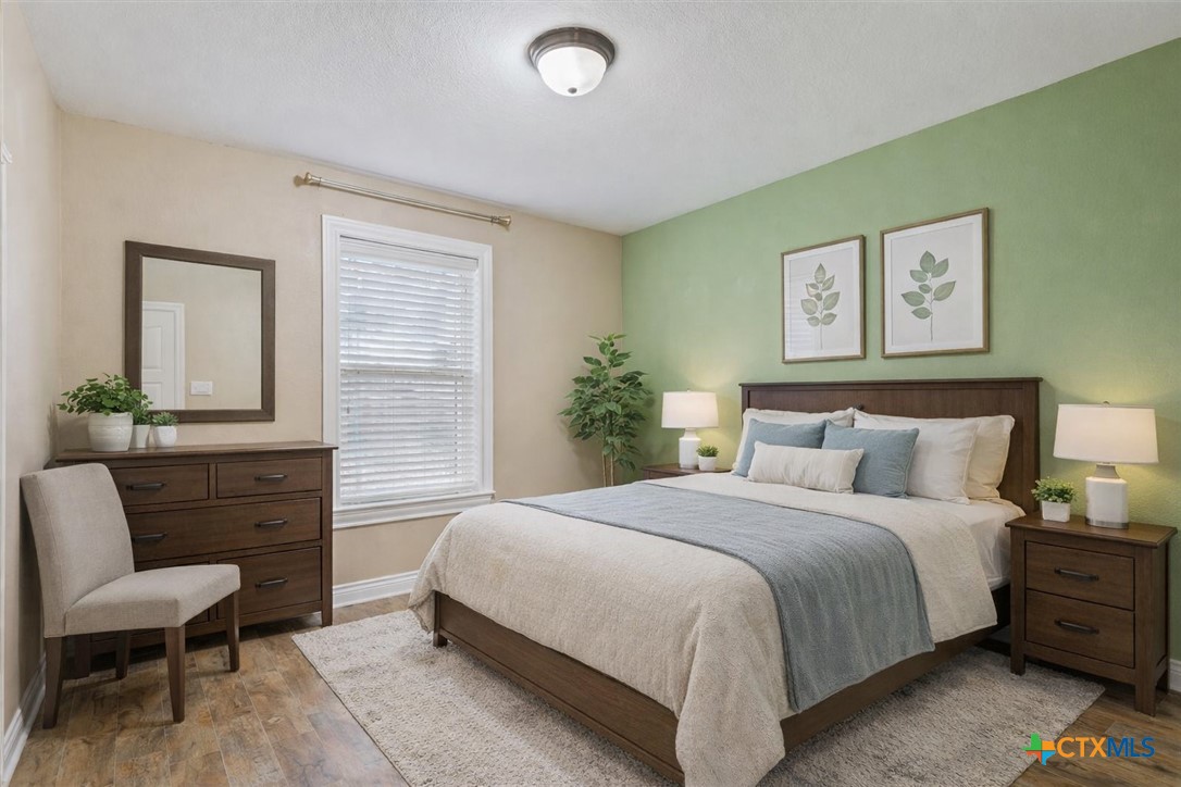 198 Sheridan Loop Belton, TX 76513 - Photo 26 of 31 a bedroom with a bed and a chair