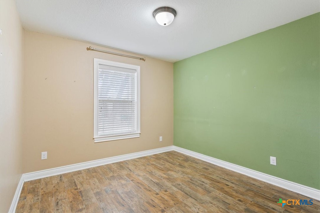 198 Sheridan Loop Belton, TX 76513 - Photo 27 of 31 a view of an empty room with wooden floor and a window