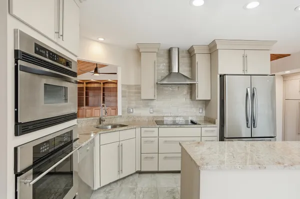 a kitchen that has a cabinets stove and refrigerator