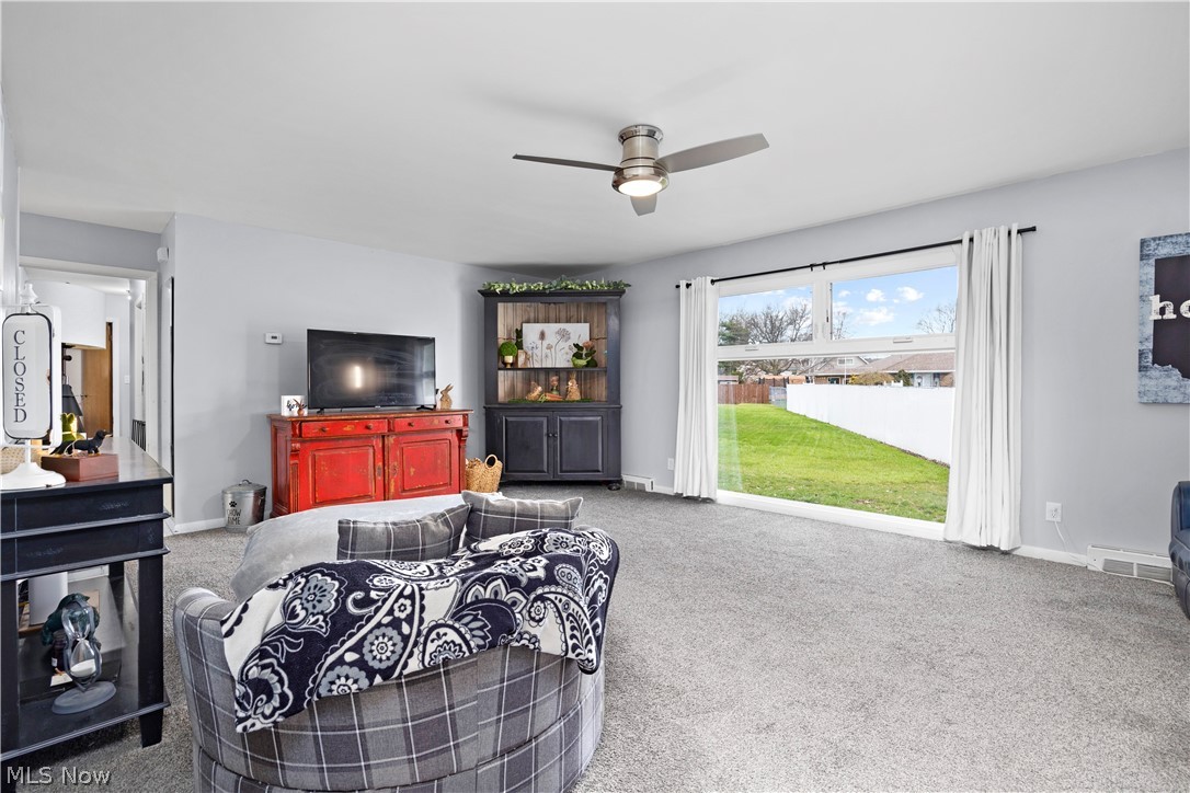 3008 Merriweather Road Sandusky, OH 44870 - Photo 10 of 37 Living room with ceiling fan and carpet flooring