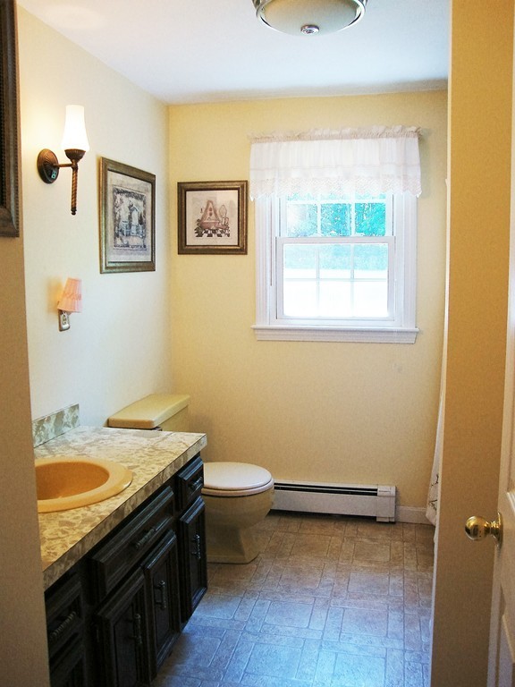 63 Pierpont Road Dudley, MA 01571 - Photo 12 of 21 a bathroom with a granite countertop sink mirror vanity and toilet