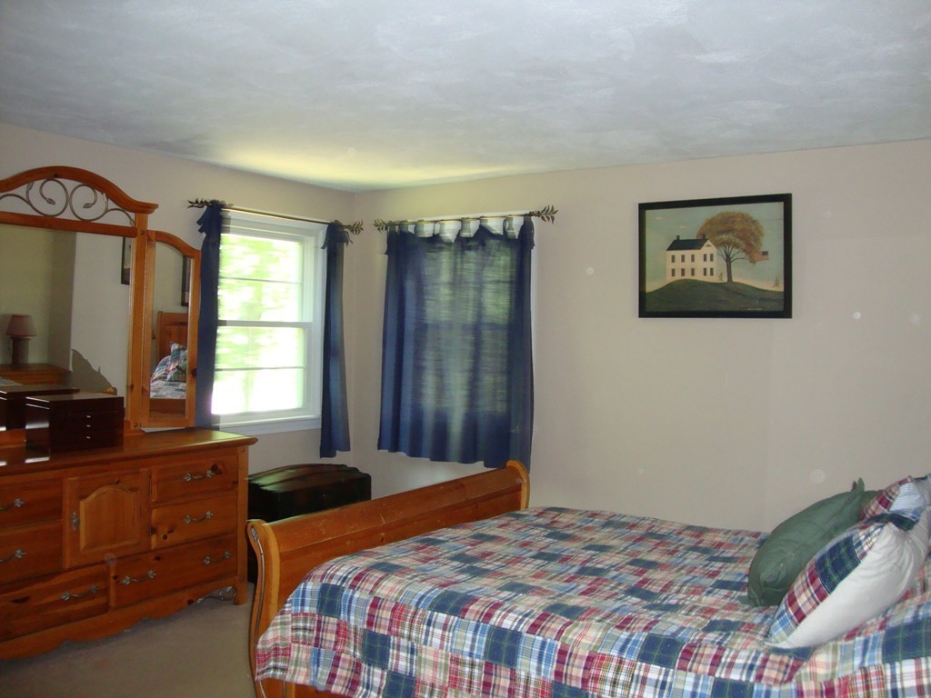 63 Pierpont Road Dudley, MA 01571 - Photo 17 of 21 a bedroom with a bed and a flat screen tv