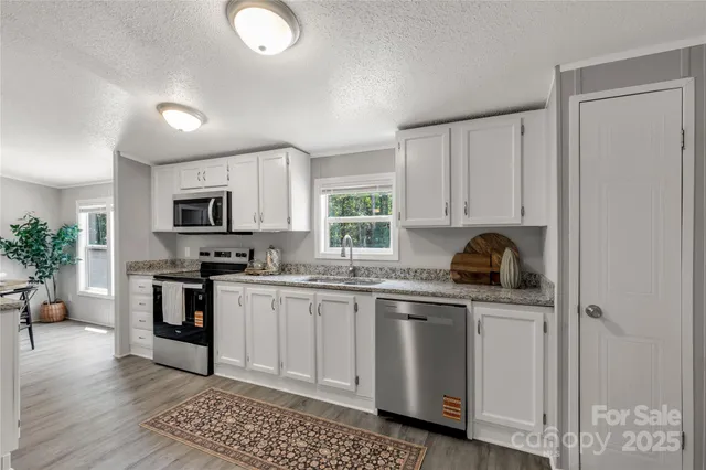 a kitchen with white cabinets and appliances