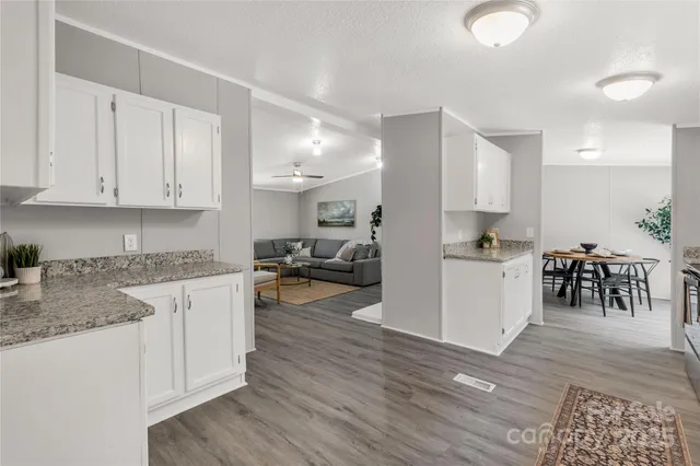 a kitchen with white cabinets and counter space