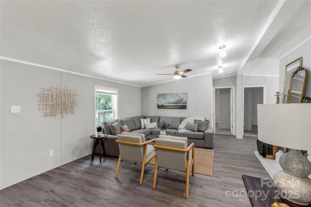 a living room with furniture and a wooden floor
