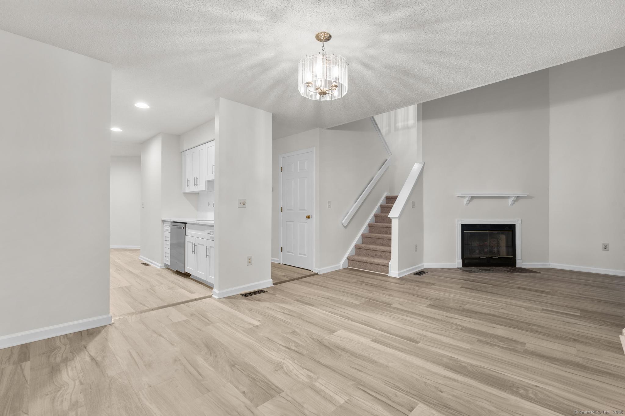 98 Crown Ridge Newington, CT 06111 - Photo 13 of 37 a view of a hallway with wooden floor and staircase