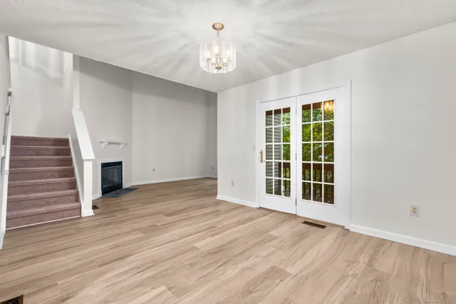 a view of a livingroom with wooden floor and a ceiling fan