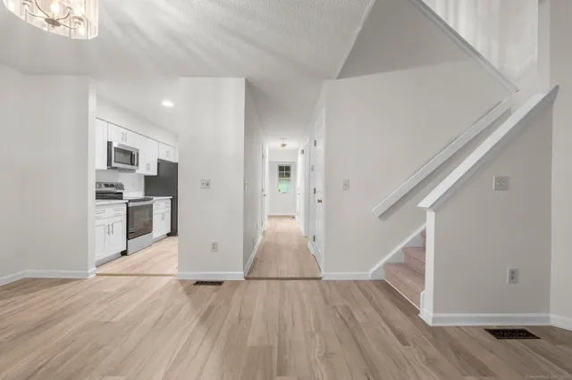 a view of kitchen with wooden floor and electronic appliances