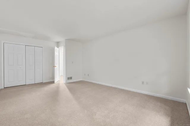 a view of an empty room and entryway