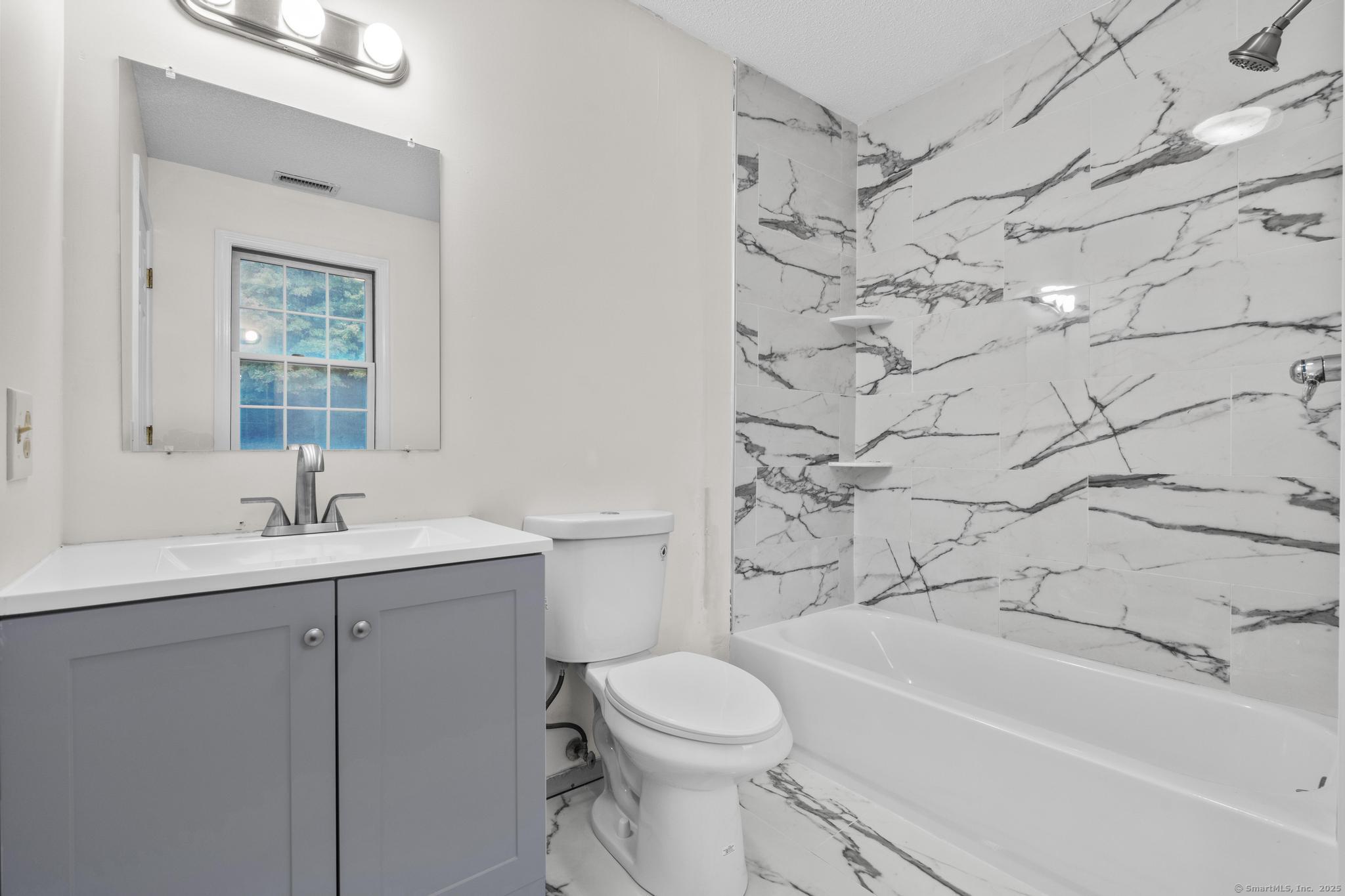 98 Crown Ridge Newington, CT 06111 - Photo 26 of 37 a bathroom with a sink a toilet and shower