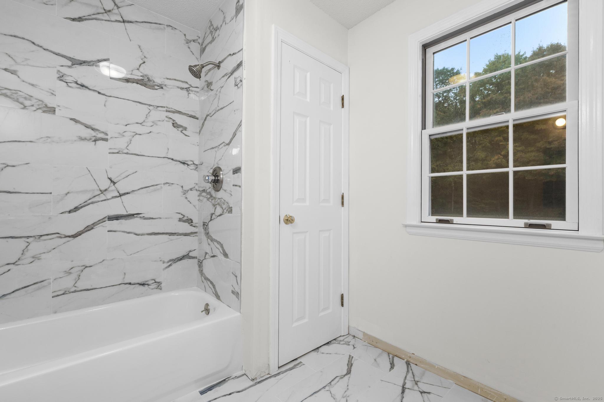 98 Crown Ridge Newington, CT 06111 - Photo 28 of 37 a bathroom with a bathtub