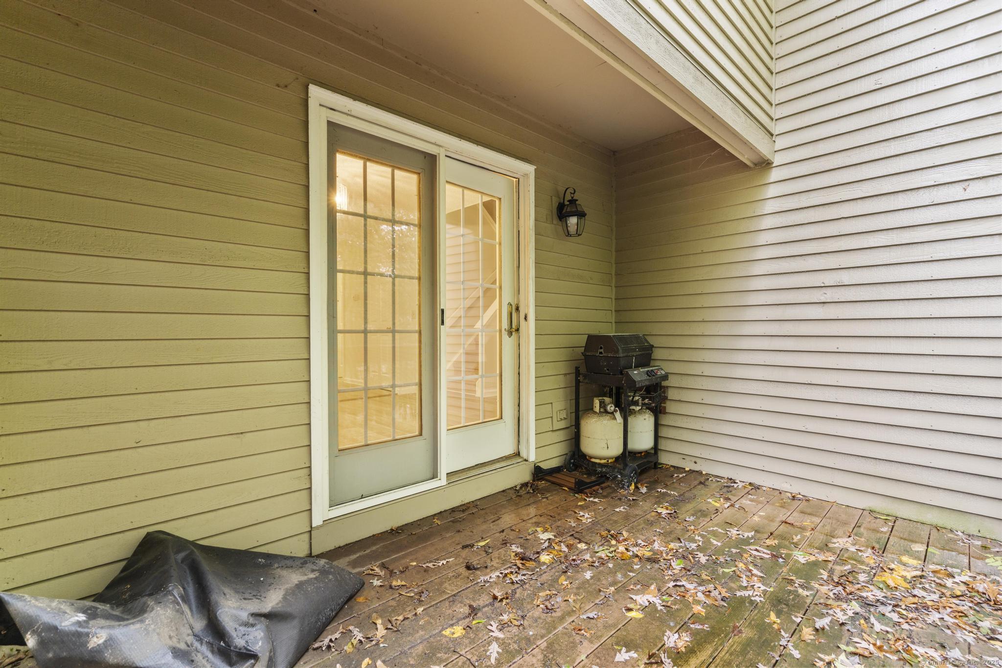 98 Crown Ridge Newington, CT 06111 - Photo 32 of 37 a view of a patio with a table and chairs and wooden floor