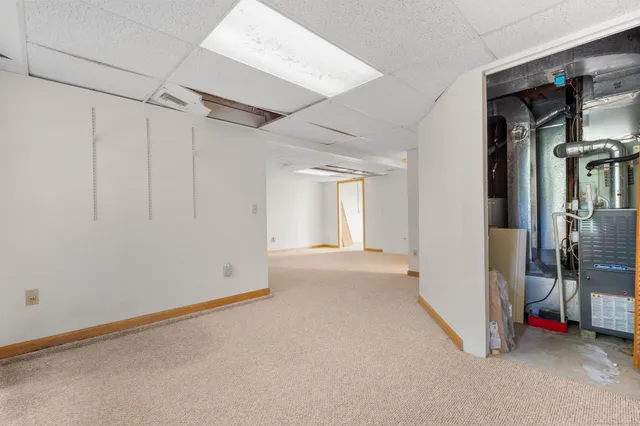 a view of a livingroom with an empty space and a window