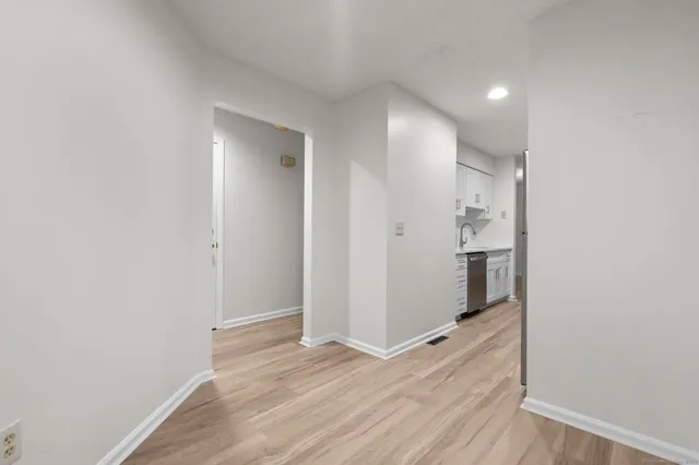 a view of hallway with wooden floor