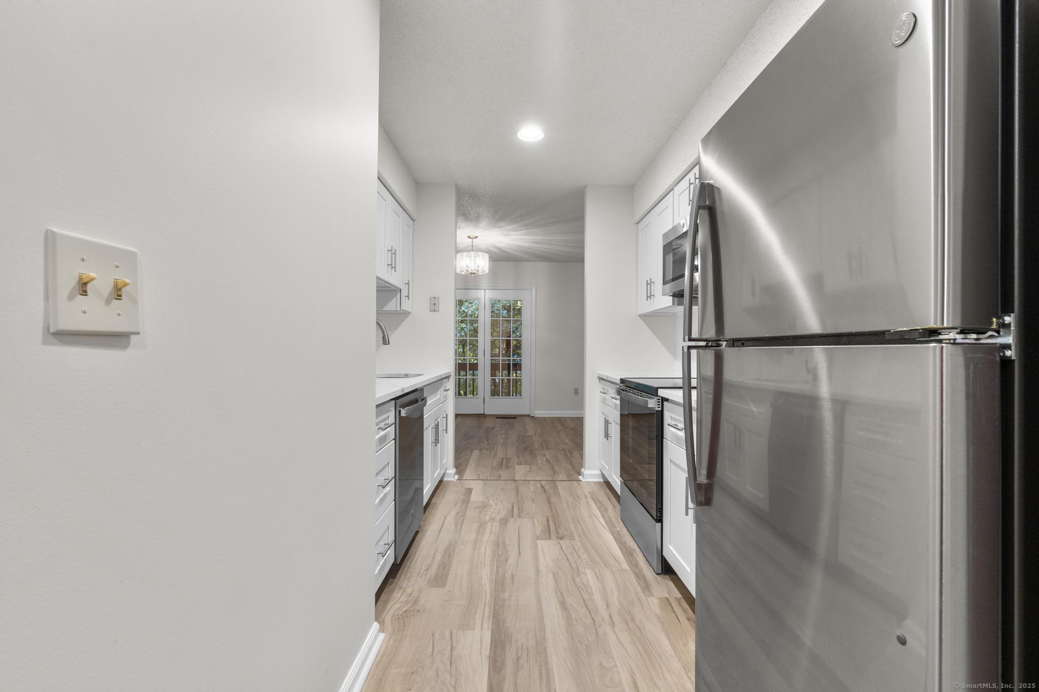 98 Crown Ridge Newington, CT 06111 - Photo 8 of 37 a view of entryway with wooden floor