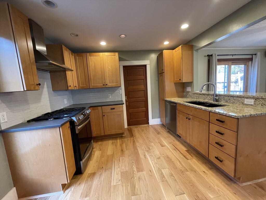 492 Elm Street Northampton, MA 01060 - Photo 14 of 31 a kitchen with stainless steel appliances granite countertop a sink stove and refrigerator
